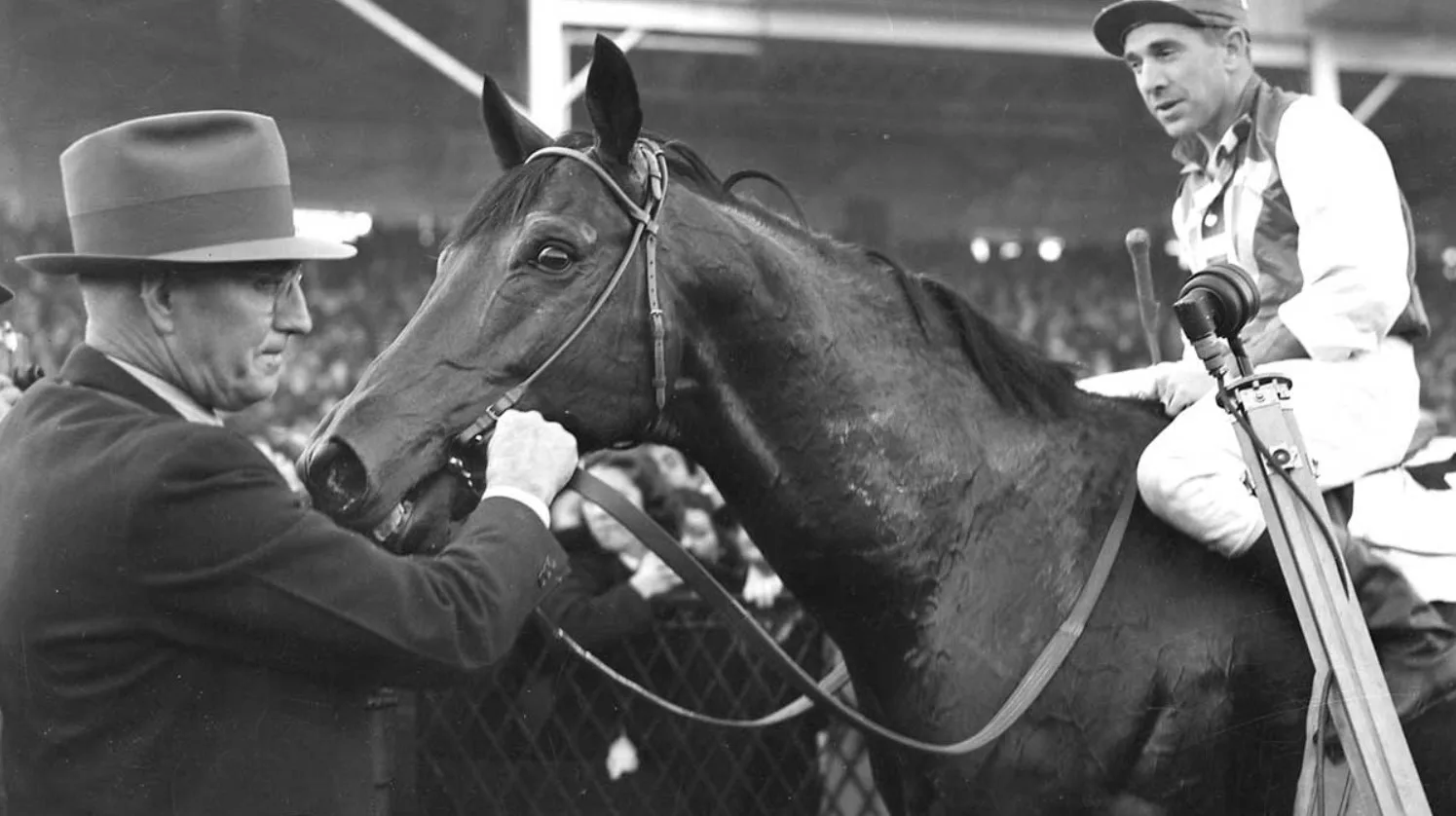 Seabiscuit with his trainer after a race